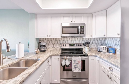 Surf City Condo | Beautifully decorated condo with view of the pool and ocean in perfect location.