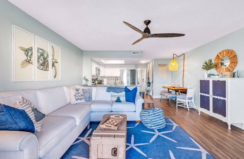 Surf City Condo | Beautifully decorated condo with view of the pool and ocean in perfect location.