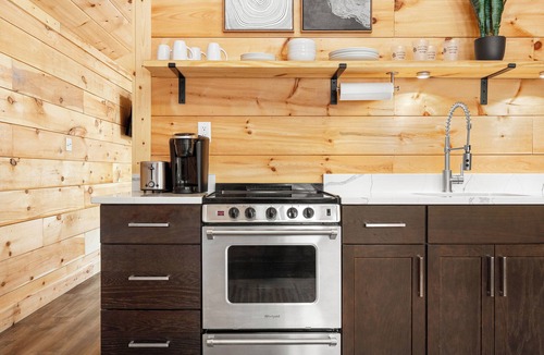 Hartwell RV Rental | Cabin #2: One king-size bed with a full kitchen for cooking and a large gravel parking pad beside the cabin for easy boat trailer storage.