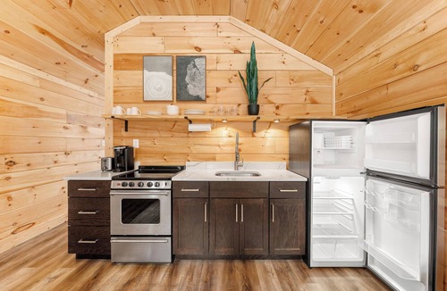Hartwell RV Rental | Cabin #2: One king-size bed with a full kitchen for cooking and a large gravel parking pad beside the cabin for easy boat trailer storage.