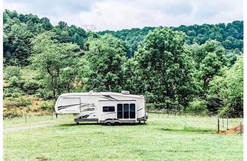 Burks Fork Cabin | Camper in middle of farm setting with creek view