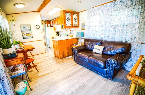 Eddyville Cabin | Deckside Haven 1 - Tiny living space with a queen bed, and 3 twin beds perfect for kids