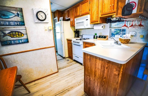 Eddyville Cabin | Deckside Haven 1 - Tiny living space with a queen bed, and 3 twin beds perfect for kids