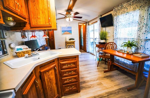 Eddyville Cabin | Deckside Haven 1 - Tiny living space with a queen bed, and 3 twin beds perfect for kids