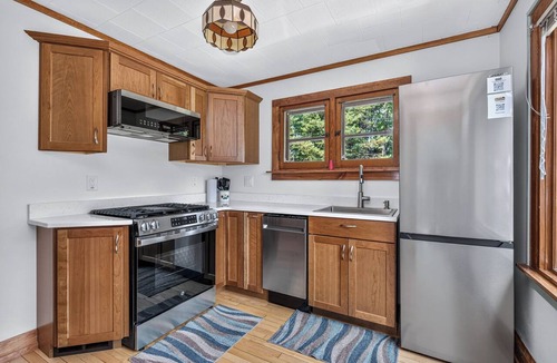 St Germain House | Gorgeous lakefront cabin, wrap-around enclosed porch, dock!