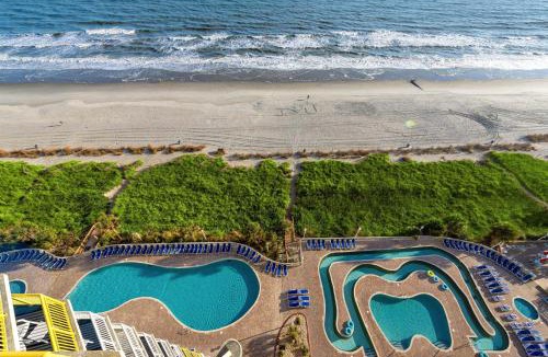 Crescent Beach House | Heated Pools & Sunrise View: Baywatch Resort Condo