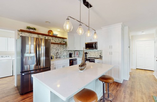 Hampstead House | Idyllic retreat with surfboards, hot tub, open layout, & firepit - dog-friendly