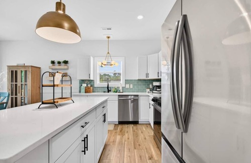 Tranquil Harbour House | Lux Oak Island Retreat | Walk to Beach | Private Suite + Fenced Yard!