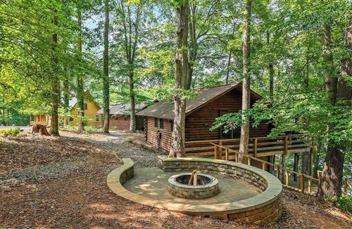 Union Hall Cabin | Plenty of Water on the main channel. Perched on a bluff with breathtaking sunrise views over the lake, this remodeled 2BR/1BA log cabin offers memory-foam beds, well-stocked granite kitchen (farm-fresh eggs!), covered deck, stone fire pit, huge dock.
