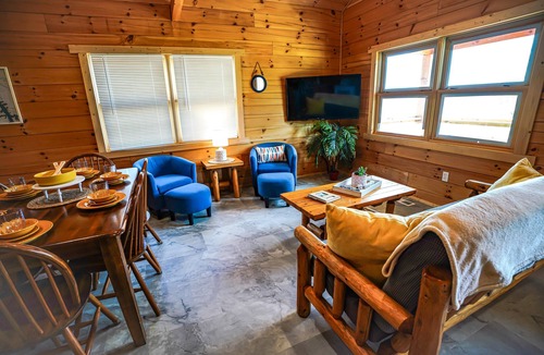 Eddyville Cabin | Waterfront Sunrise Bay Log Cabin - Lake Barkley Log is your perfect family escape on Lake Barkley! This charming log cabin offers two bedrooms, a sleeping loft, full kitchen, and bathroom with shower.
