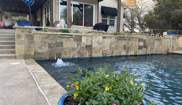 Tranquil Waterfront property with a pool, hot tub, fire-pit & large patio. in Graham