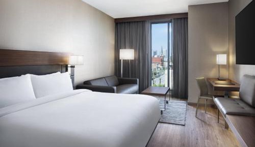 King Guest Room with Sofa Bed and City View